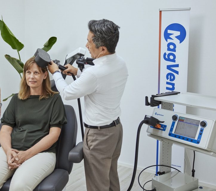Lady having repetitive transcranial magnetic stimulation therapy